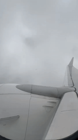 Passenger films cloudy aerial view from airplane over Georgia
