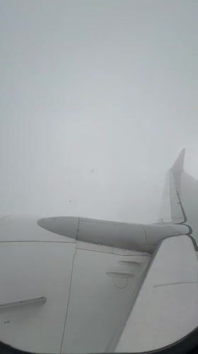 Passenger films cloudy aerial view from airplane over Georgia