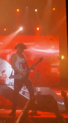 Guitarist performs under colored lights in Sofia concert