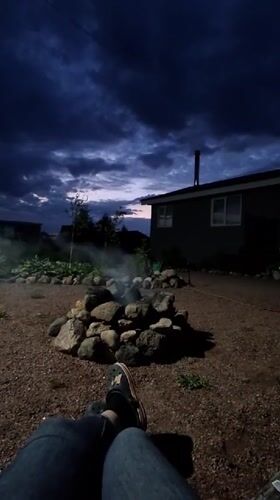 Evening campfire gathering in Kempelevo backyard, June 2026