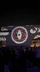 Crowd watches video projections on Barcelona building facade