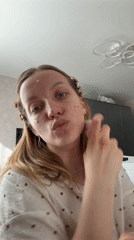 Woman applies makeup in Reshetnikovo beauty routine session