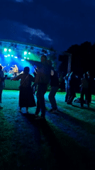 Outdoor concert night in Priekule, Latvia — band plays, crowd dances