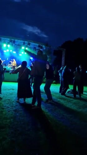 Outdoor concert night in Priekule, Latvia — band plays, crowd dances