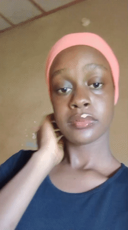 Woman in pink headscarf poses for camera