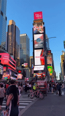 Times Square buzzing on a bright late-summer day