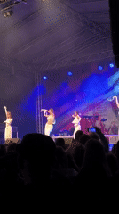 Live musical performances draw crowds to illuminated stage