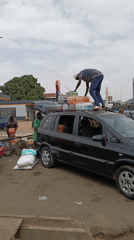 Street vendors transport goods on busy city thoroughfare