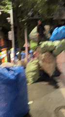 Person stands atop bag-loaded truck in Yuzhong District