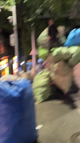 Person stands atop bag-loaded truck in Yuzhong District