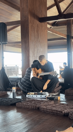 Musicians perform dawn concert in wooden pavilion, Mengwi Indonesia