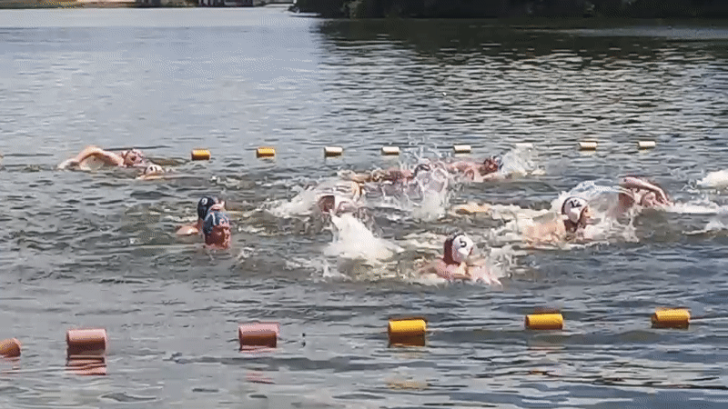 Open water swim race with competitors spread across the course
