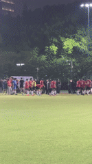 Soccer players gather on Shanghai field at night