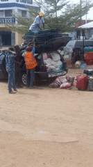 Travelers load vehicles with belongings in Dadi Riba, Nigeria