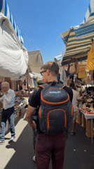 Morning market bustles with vendors and shoppers in Catania
