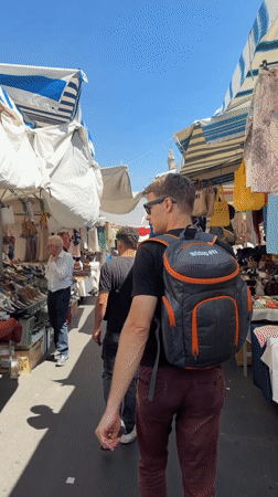 Morning market bustles with vendors and shoppers in Catania