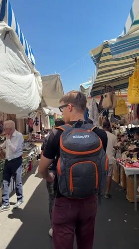 Morning market bustles with vendors and shoppers in Catania