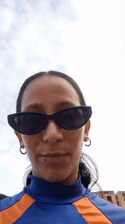 Woman films smartphone selfies on Porlamar street