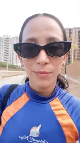 Woman films smartphone selfies on Porlamar street