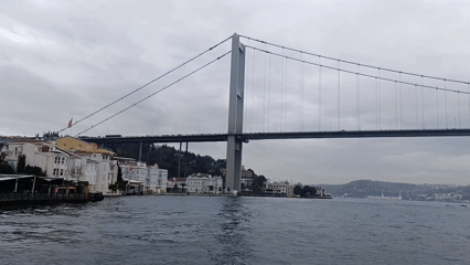 Boat journey captures Bosphorus Bridge and Istanbul waterfront landmarks