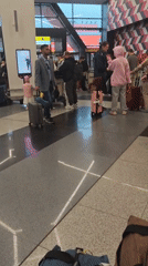 Airport terminal bustling with travelers and luggage queues
