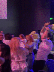 Dancing crowd enjoys nightclub scene in Riga with DJ