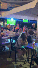 Nesebar outdoor bar screens a soccer match on a summer night