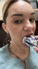 Woman eats coffee-flavored chocolate bar in Vsevolozhsk, Russia