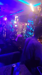 Nightlife scene captured at neon-lit bar in Obosi, Nigeria