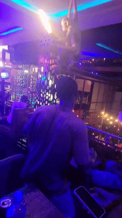 Nightlife scene captured at neon-lit bar in Obosi, Nigeria
