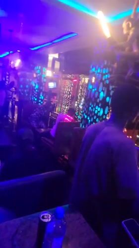 Nightlife scene captured at neon-lit bar in Obosi, Nigeria