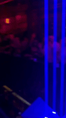 DJ performs at Kragujevac nightclub with dancing crowd