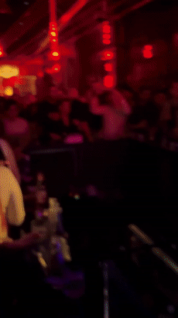 DJ performs at Kragujevac nightclub with dancing crowd