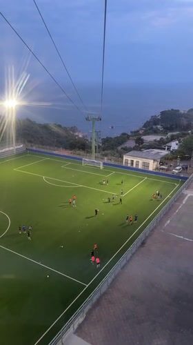Evening soccer match observed from aerial view in Taormina