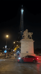 Paris nighttime: Eiffel Tower sparkles, motorcycle rides through streets
