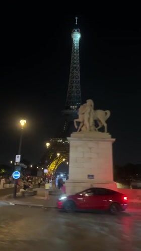 Paris nighttime: Eiffel Tower sparkles, motorcycle rides through streets