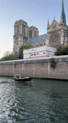 Small boat with green lights navigates Paris river