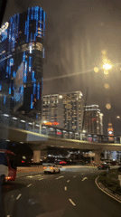 Night driving footage captures illuminated Macao cityscape with blue lights