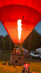 Red hot air balloons draw crowds at outdoor event