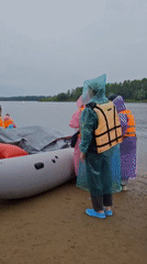 Rainy-day rafting launch on a Russian riverbank