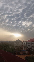 Sunrise breaks through clouds over Nkpor, Nigeria neighborhood