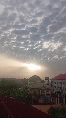 Sunrise breaks through clouds over Nkpor, Nigeria neighborhood