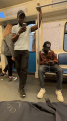 Man uses smartphone on Moscow subway while commuting