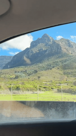 Mountain range filmed from car window in Cape Town