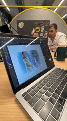 Person works on MacBook with InDesign in Novate Milanese office