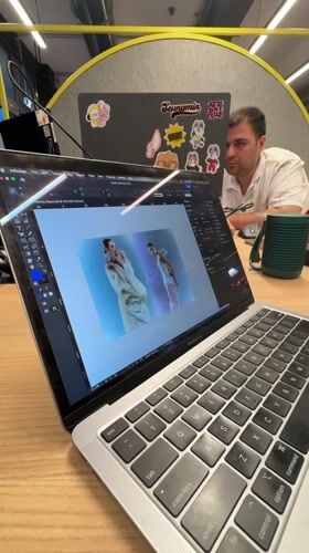 Person works on MacBook with InDesign in Novate Milanese office