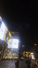 Drone light show spells "SKY EDGE" over Bangkok plaza