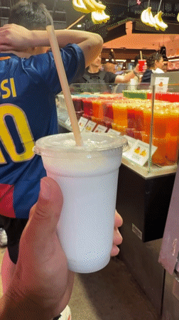 Barcelona market scene features person in Messi jersey