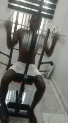 Man exercises indoors, later rests on sofa