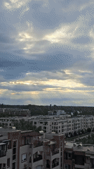 Dramatic clouds and sunbeams observed over urban cityscape